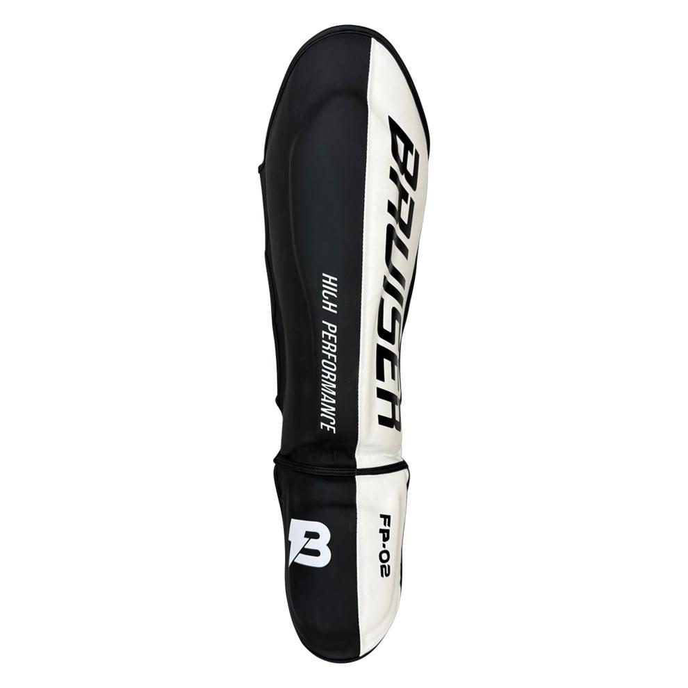 Espinillera de boxeo y muay thai negra y blanca. Logo Bruiser en la parte frontal lateral. Relleno de alta densidad que absorbe golpes y protege espinillas. Sistema de velcro reforzado para entrenamiento de contacto. Imagen frontal.