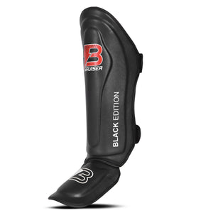 Espinillera Bruiser color negro con detalles blancos. Logo de la marca en el centro y en empeine. Diseño ligero con empeine hecho de neopreno. Sistema de velcro para más firmeza.