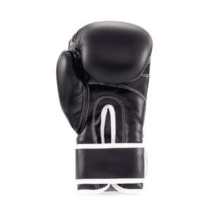 Guantes de Muay Thai marca Tiger color negro y rosa por detrás. Hechos de polipiel con acolchado. Ajuste seguro. Imagen frontal.