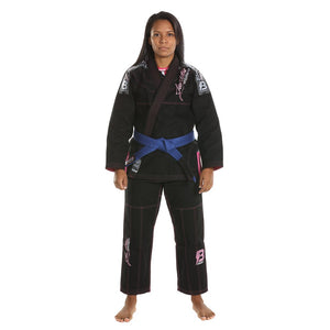 Kimono de Jiu Jitsu para mujer marca Bruiser color negro con detalles rosas. Llevado por modelo con brazos estirados mirando al frente. Hecho de algodón con costuras reforzadas y tejido doble capa.