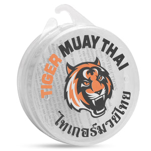 Protector bucal naranja de la marca Tiger Muay Thai, para boxeo, MMA y deportes de contacto. Materiales de alta calidad, protector es moldeable con calor.
Caja protectora blanca con logotipo de la marca.
Diseño cómodo y resistente pensado para entrenamiento y sparring.