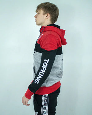 Perfil izquierdo de sudadera con cremallera y capucha "Top King" color roja, negra y gris, llevada por modelo con brazos estirados. Logo "Top King" en manga izquierda escrito en letras blancas.