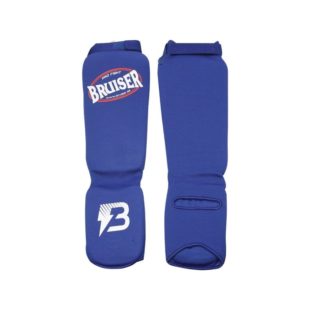 Espinilleras calcetín Bruiser por delante y por detrás color azul. Tejido elástico con relleno de espuma. Velcro con ajuste seguro. 