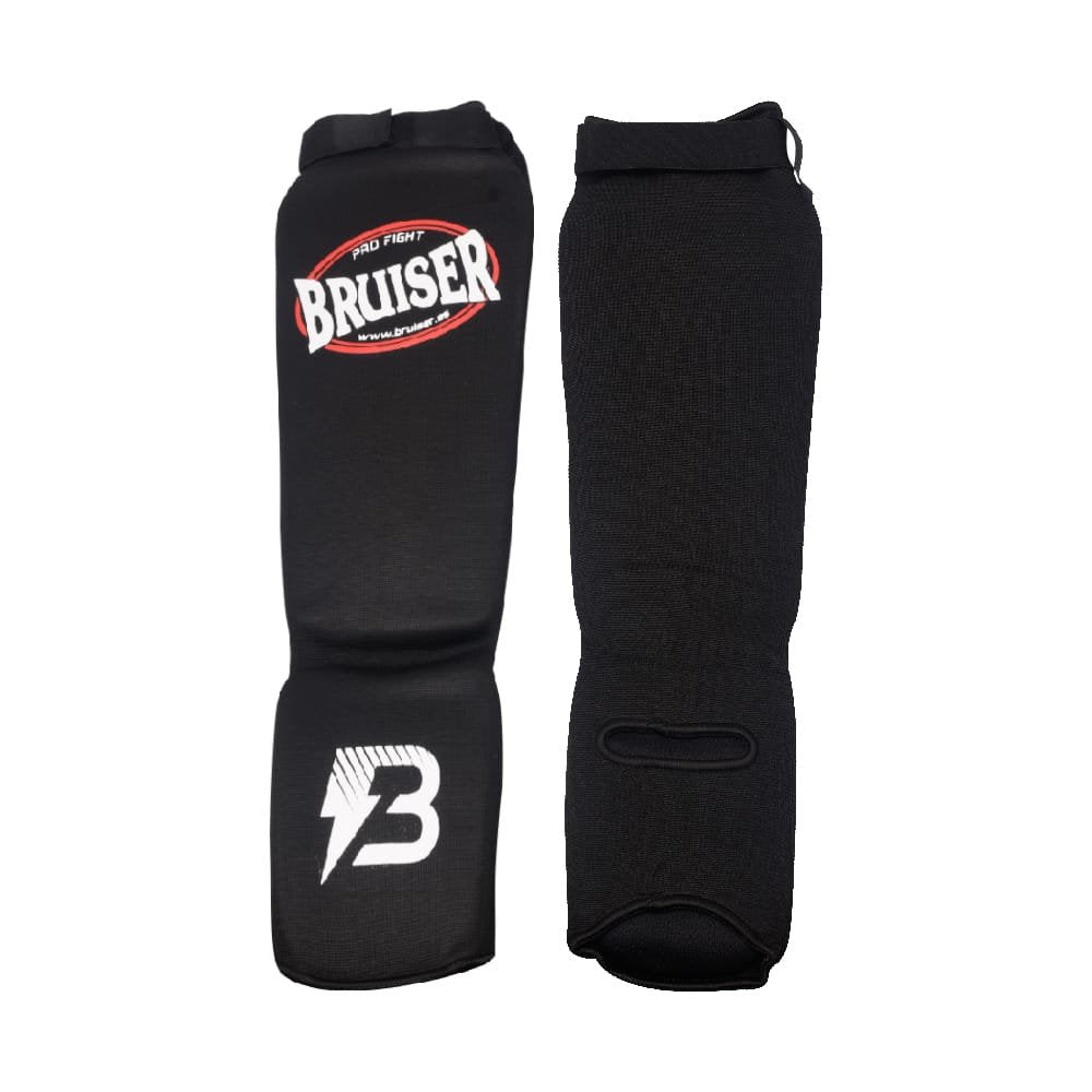 Espinilleras calcetín Bruiser por delante y por detrás color negro. Tejido elástico con relleno de espuma. Velcro con ajuste seguro.