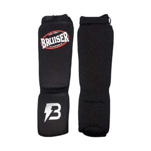 Espinilleras calcetín Bruiser por delante y por detrás color negro. Tejido elástico con relleno de espuma. Velcro con ajuste seguro.