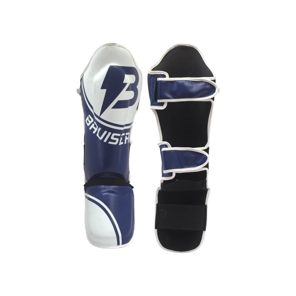 Espinilleras Bruiser color azul y blanco. Hechas de polipiel con empeine de neopreno. Espinilla elevada y cresta para los pies para una protección completa. Cierre de velcro. 