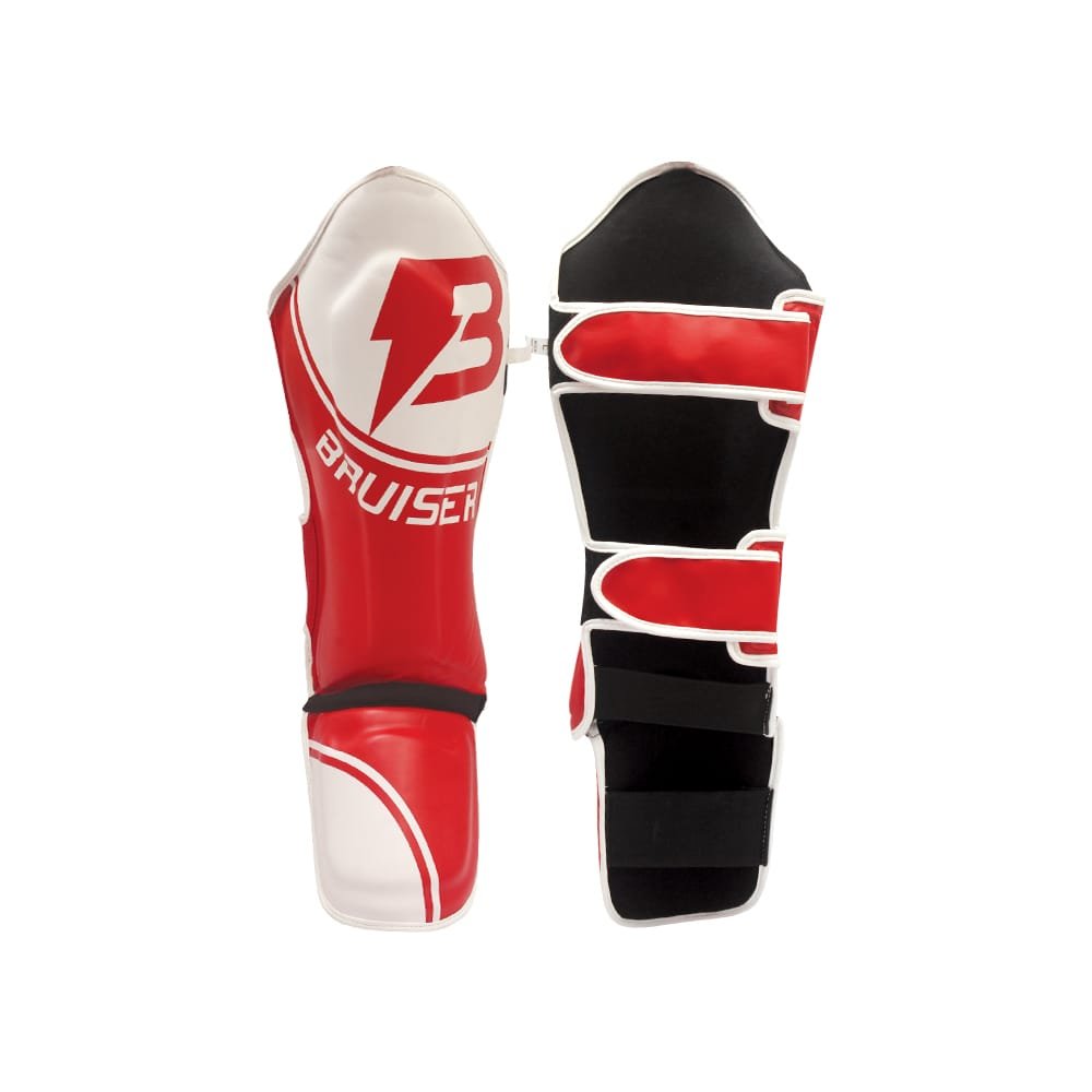 Espinilleras Bruiser color rojo y blanco. Hechas de polipiel con empeine de neopreno. Espinilla elevada y cresta para los pies para una protección completa. Cierre de velcro. 