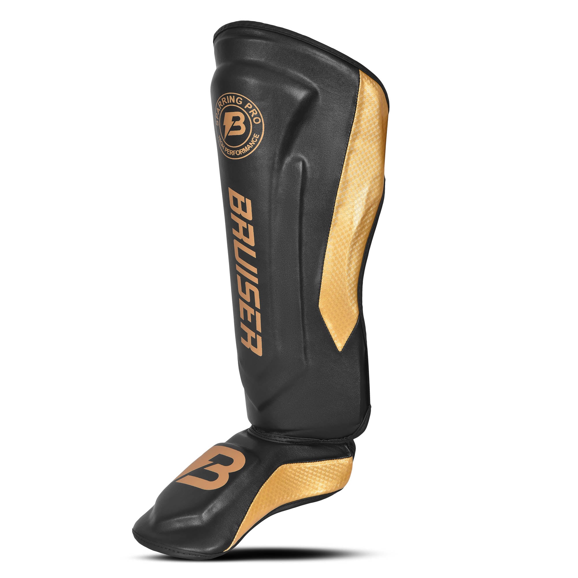 Espinillera marca Bruiser color negro y dorado. Logo en el centro. Hecha de microfibra y rellenas de espuma y latex. Cierres anchos de velcro. Perfil izquierdo.