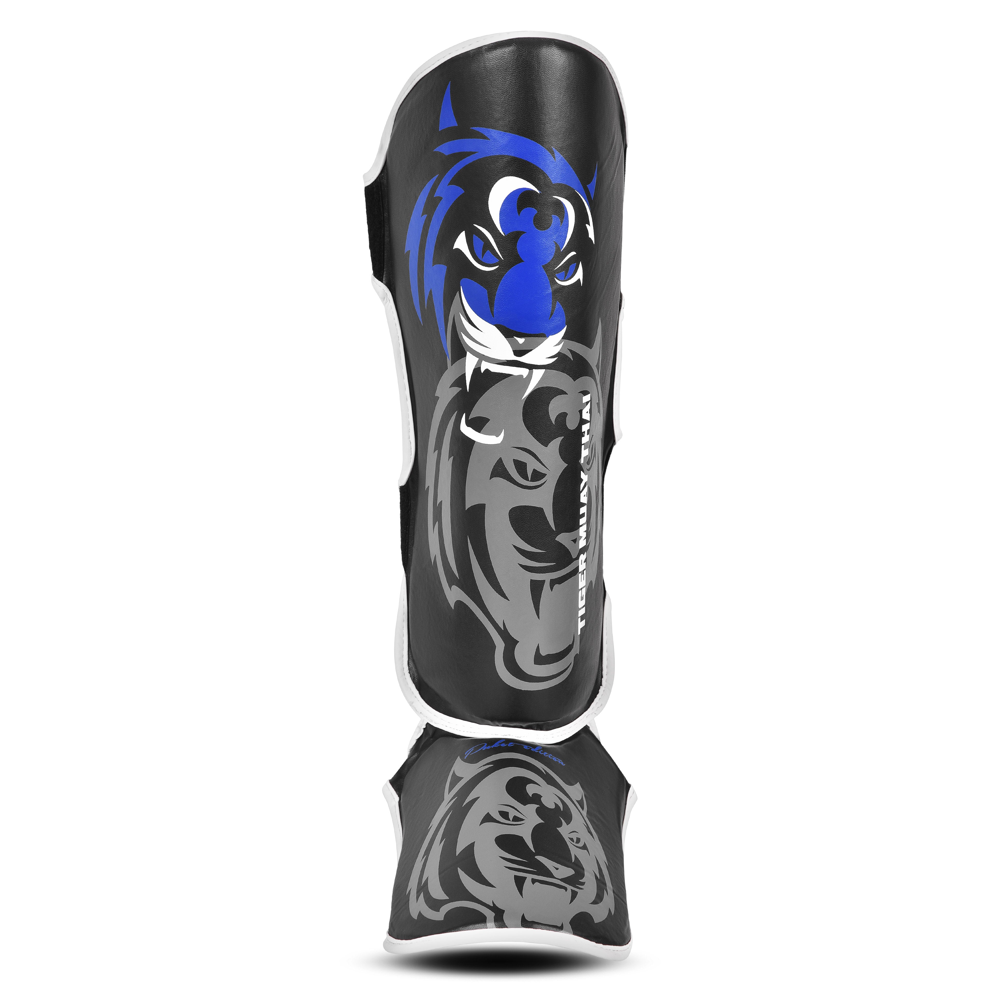 Espinilleras marca Tiger por delante color negro y azul. Logo en el centro. Hechas de polipiel con espuma absorbente. 