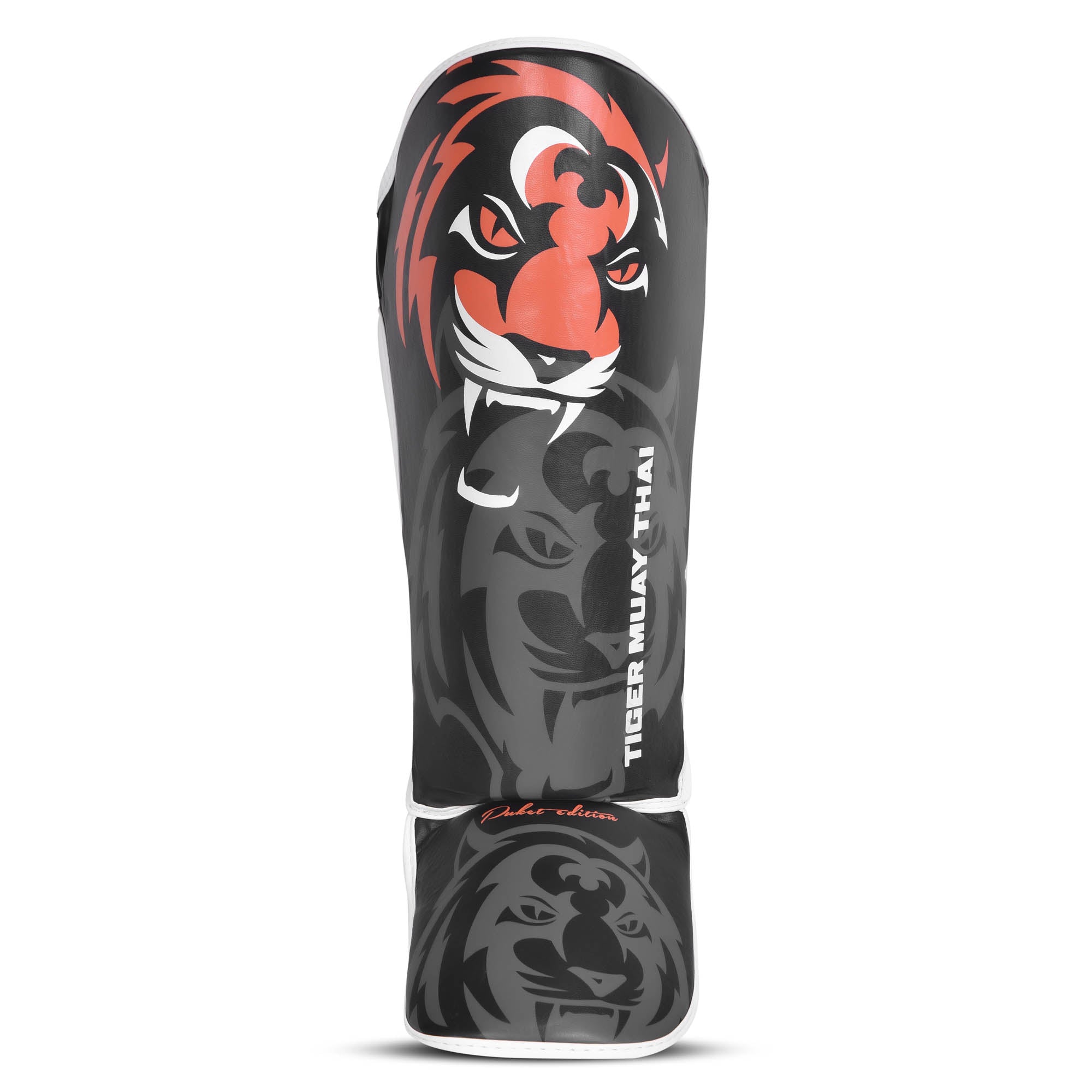 Espinillera marca Tiger para niños por delante color negro y naranja. Logo en el centro. Hecha de polipiel con espuma absorbente. 