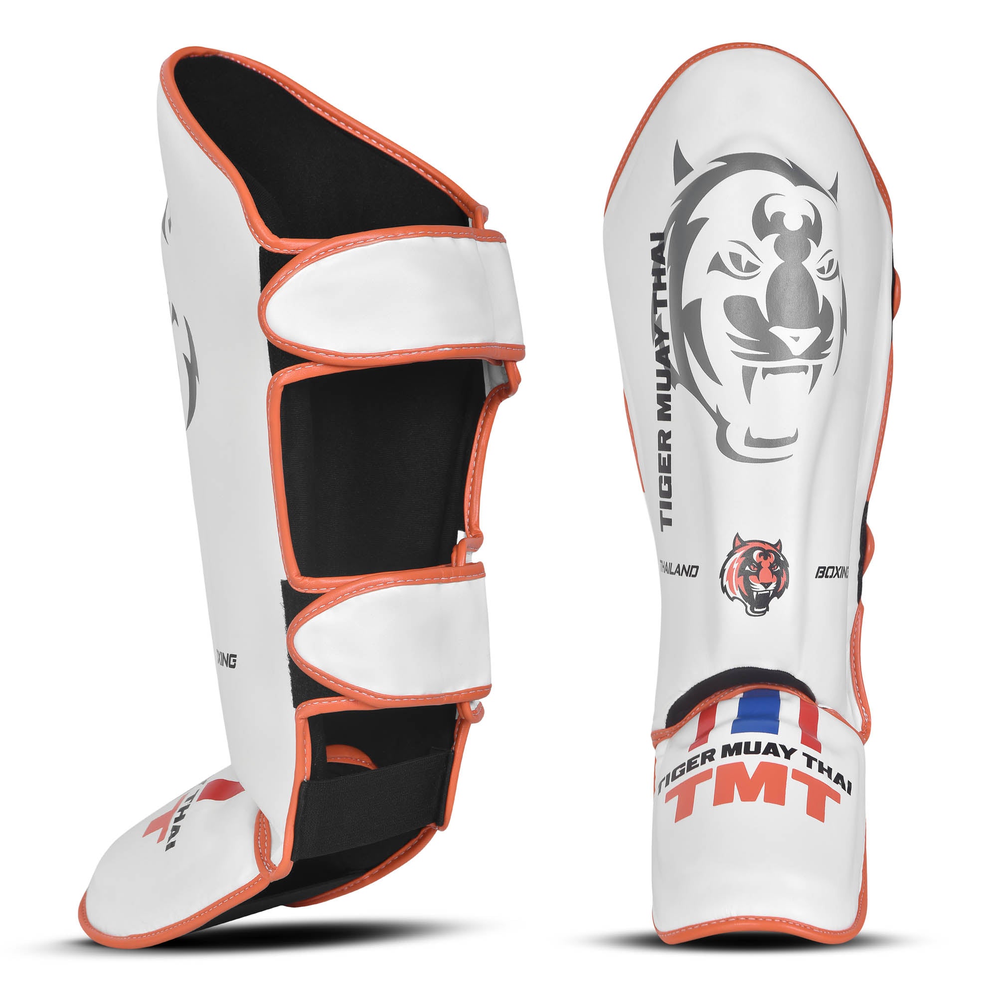 Espinilleras marca Tiger por delante y por detrás color blanco y naranja. Logo en el centro. Hechas de polipiel con espuma absorbente. 