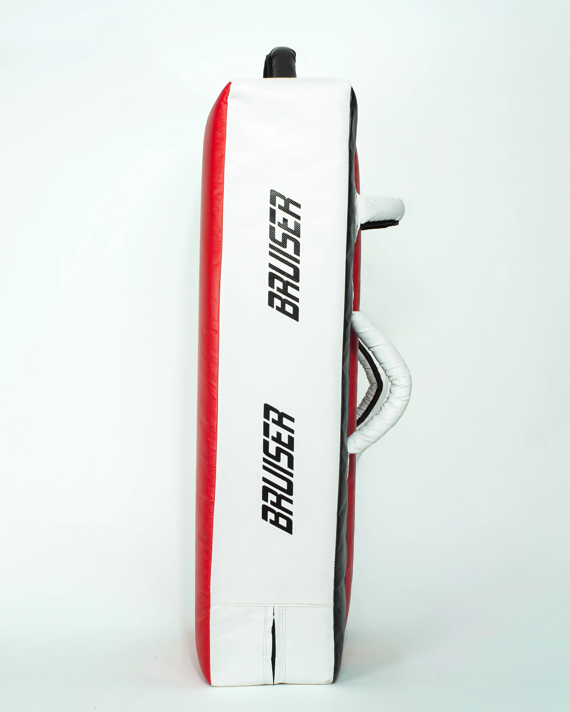 Pao escudo gigante "Bruiser" rojo con detalles blancos y negros. Hecho de materiales de alta calidad con relleno de alta densidad. "Bruiser" escrito en los laterales. Agarres reforzados. Para Boxeo, Muay Thai, Karate, Taekwondo, Kickboxing. Perfil izquierdo.