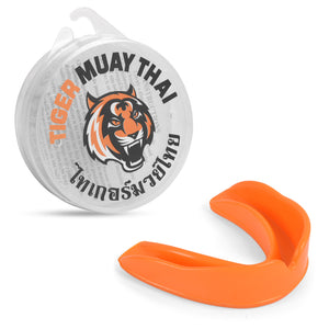 Bucal Tiger Muay Thai naranja y detrás de él su respectiva cajita donde guardarlo. 