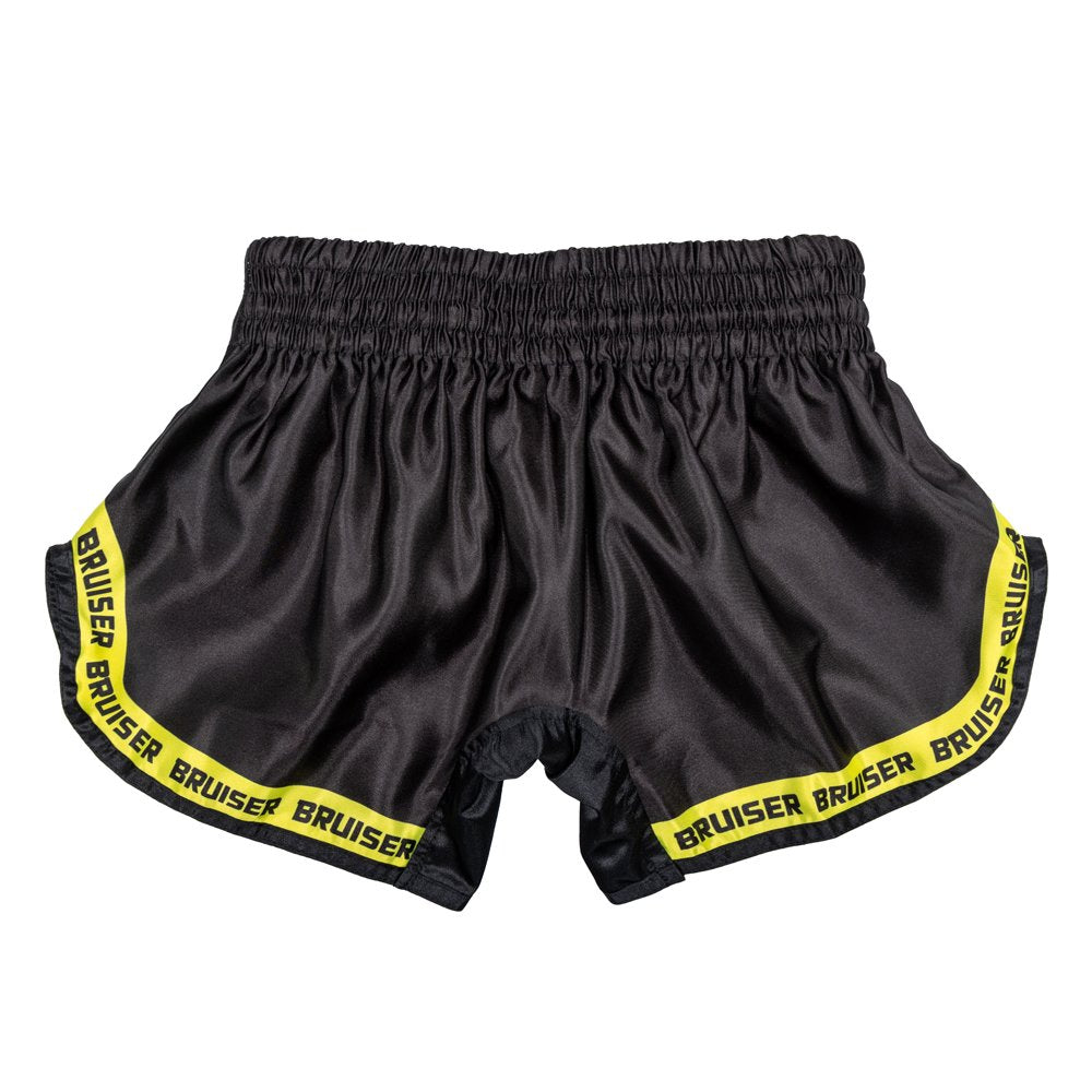 Pantalón corto infantil de Muay Thai marca Bruiser color negro y amarillo. Logo en el centro. Hecho de poliéster. Imagen trasera.  
